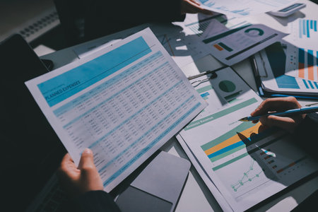 Group of business women working on a financial data expenses document.の写真素材