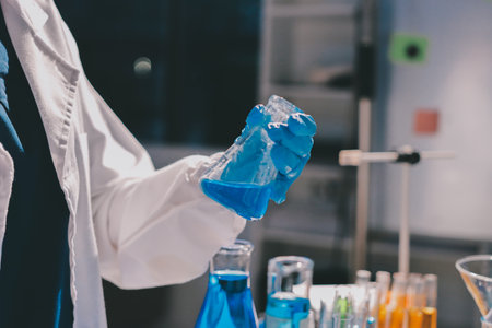 Scientist pipetting medical samples into microplate in laboratoryの写真素材