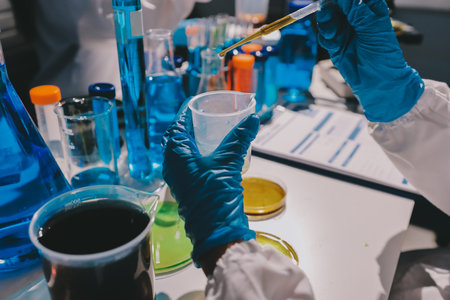Scientist pipetting medical samples into microplate in laboratoryの写真素材