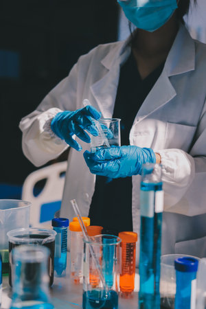 Scientist pipetting medical samples into microplate in laboratoryの写真素材