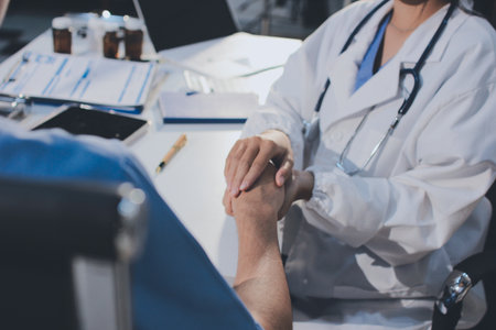 Doctor came to check the patient and shook his hand to encourage. Comforting the sick and treating the best, cured in the hospital.の写真素材