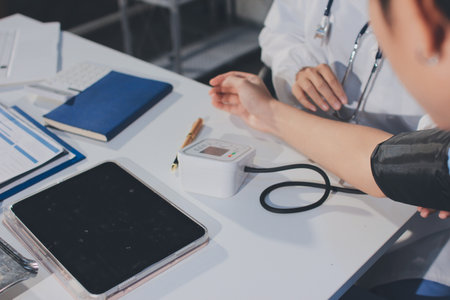 Doctor checking patient arterial blood pressure in hospital. Health care Conceptの写真素材