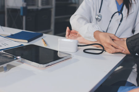 Doctor checking patient arterial blood pressure in hospital. Health care Conceptの写真素材