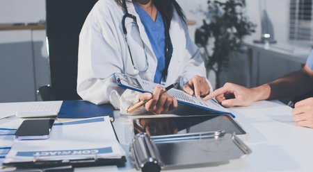 Young brunette woman having consultation at doctor office duringの写真素材