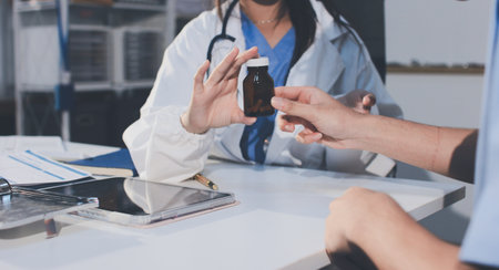 Young brunette woman having consultation at doctor office duringの写真素材