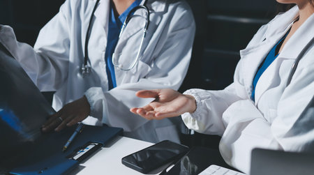 Male and female doctors are having a meeting in a hospital room.の写真素材