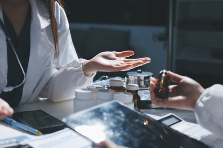 Male and female doctors are having a meeting in a hospital room.の写真素材