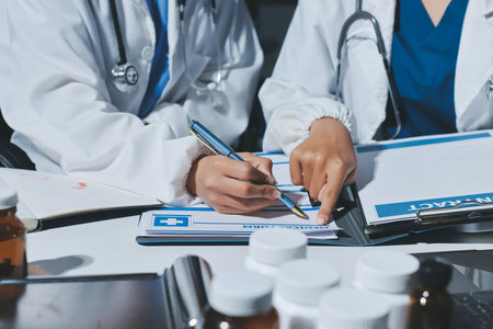 Male and female doctors are having a meeting in a hospital room.の写真素材