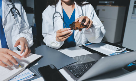 Male and female doctors are having a meeting in a hospital room.の写真素材