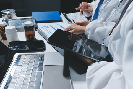 Male and female doctors are having a meeting in a hospital room.の写真素材