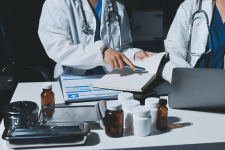 Male and female doctors are having a meeting in a hospital room.の写真素材