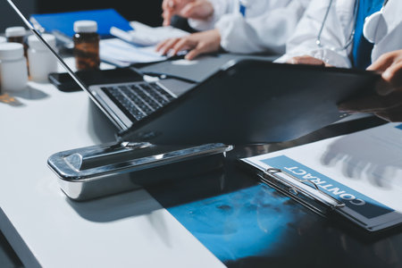 Male and female doctors are having a meeting in a hospital room.の写真素材