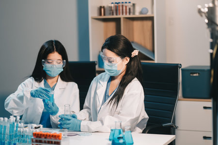 Research, experiment and medical trial being done by a scientist in a lab, science facility or hospital. One young, serious and professional researcher organizing, sorting or making a discoveryの写真素材