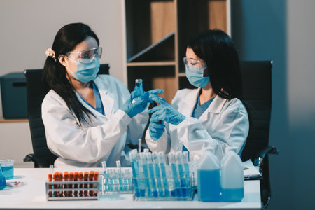 Research, experiment and medical trial being done by a scientist in a lab, science facility or hospital. One young, serious and professional researcher organizing, sorting or making a discoveryの写真素材