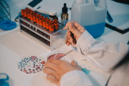 Research, experiment and medical trial being done by a scientist in a lab, science facility or hospital. One young, serious and professional researcher organizing, sorting or making a discoveryの写真素材
