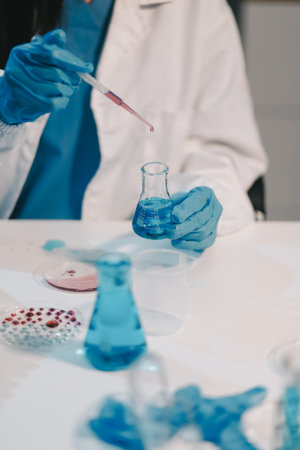 Research, experiment and medical trial being done by a scientist in a lab, science facility or hospital. One young, serious and professional researcher organizing, sorting or making a discoveryの写真素材