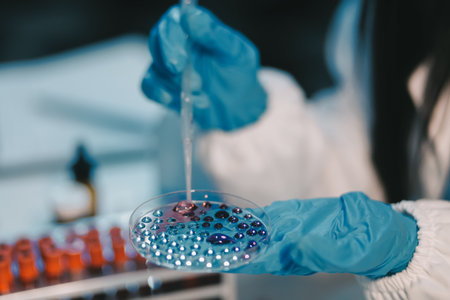 Research, experiment and medical trial being done by a scientist in a lab, science facility or hospital. One young, serious and professional researcher organizing, sorting or making a discoveryの写真素材