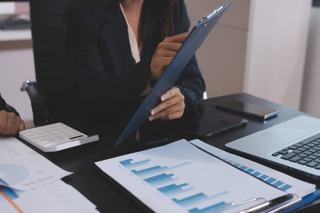 Team of business people working together in the meeting room office,
teamwork background charts and graphs banner, double exposure successful teamwork,business planning concept.の写真素材