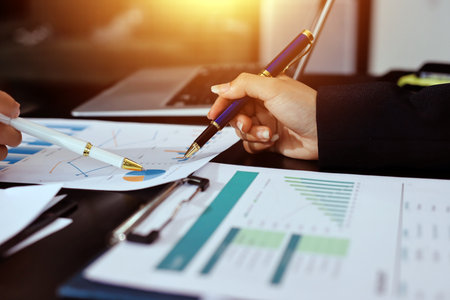 Team of business people working together in the meeting room office,
teamwork background charts and graphs banner, double exposure successful teamwork,business planning concept.の写真素材