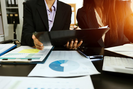 Team of business people working together in the meeting room office,
teamwork background charts and graphs banner, double exposure successful teamwork,business planning concept.の写真素材