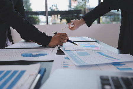 Team of business people working together in the meeting room office,
teamwork background charts and graphs banner, double exposure successful teamwork,business planning concept.の写真素材