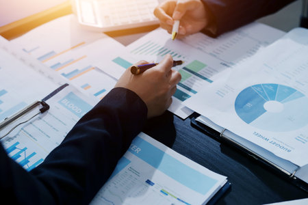 Team of business people working together in the meeting room office,
teamwork background charts and graphs banner, double exposure successful teamwork,business planning concept.の写真素材