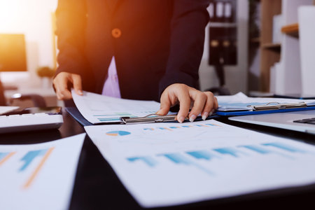 Team of business people working together in the meeting room office,
teamwork background charts and graphs banner, double exposure successful teamwork,business planning concept.の写真素材