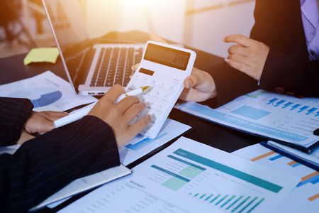 Team of business people working together in the meeting room office,
teamwork background charts and graphs banner, double exposure successful teamwork,business planning concept.の写真素材