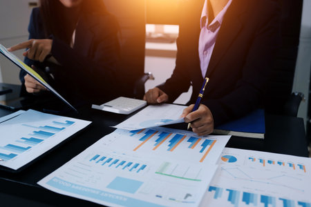 Team of business people working together in the meeting room office,
teamwork background charts and graphs banner, double exposure successful teamwork,business planning concept.の写真素材
