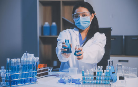 Research, experiment and medical trial being done by a scientist in a lab, science facility or hospital. One young, serious and professional researcher organizing, sorting or making a discoveryの写真素材