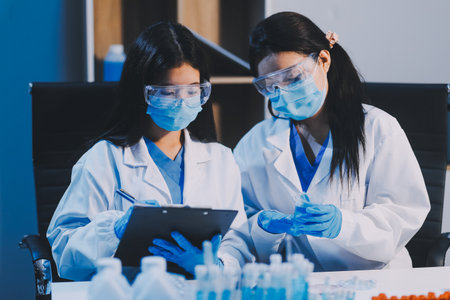 Research, experiment and medical trial being done by a scientist in a lab, science facility or hospital. One young, serious and professional researcher organizing, sorting or making a discoveryの写真素材