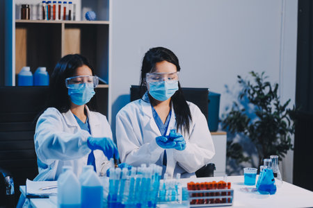 Research, experiment and medical trial being done by a scientist in a lab, science facility or hospital. One young, serious and professional researcher organizing, sorting or making a discoveryの写真素材
