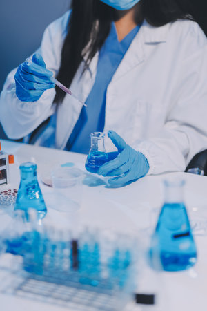 Research, experiment and medical trial being done by a scientist in a lab, science facility or hospital. One young, serious and professional researcher organizing, sorting or making a discoveryの写真素材