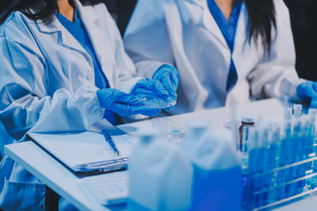 Research, experiment and medical trial being done by a scientist in a lab, science facility or hospital. One young, serious and professional researcher organizing, sorting or making a discoveryの写真素材