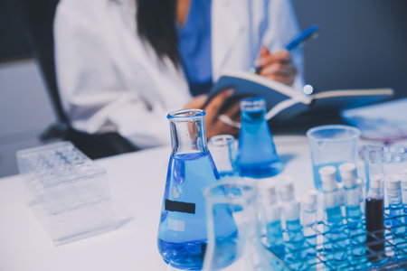 Research, experiment and medical trial being done by a scientist in a lab, science facility or hospital. One young, serious and professional researcher organizing, sorting or making a discoveryの写真素材