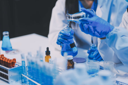 Research, experiment and medical trial being done by a scientist in a lab, science facility or hospital. One young, serious and professional researcher organizing, sorting or making a discoveryの写真素材