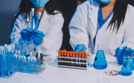 Research, experiment and medical trial being done by a scientist in a lab, science facility or hospital. One young, serious and professional researcher organizing, sorting or making a discoveryの写真素材