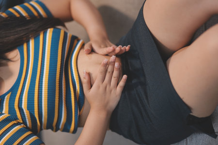 Cropped shot of woman touching and squeezing her fat belly.の写真素材