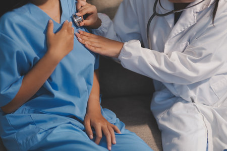 Close-up of doctor listening to a senior woman's heartbeatの写真素材