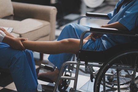 A female doctor examines an elderly patient with knee pain due to arthritis. The patient is being assisted in recovery, focusing on pain management and improving mobility.の写真素材