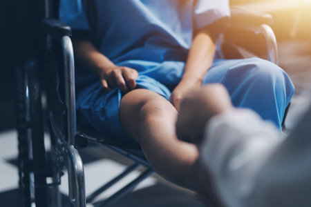 A female doctor examines an elderly patient with knee pain due to arthritis. The patient is being assisted in recovery, focusing on pain management and improving mobility.の写真素材