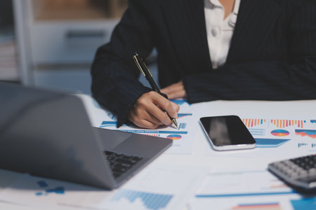 Audit concept,Administrator business man financial inspector and secretary making report calculating balance. Internal Revenue Service checking document.の写真素材