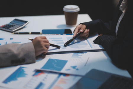 Close up of Business team analyzing income charts and graphs with modern laptop computer. Business analysis and strategy concept.の写真素材