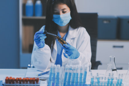 Research, experiment and medical trial being done by a scientist in a lab, science facility or hospital. One young, serious and professional researcher organizing, sorting or making a discoveryの写真素材
