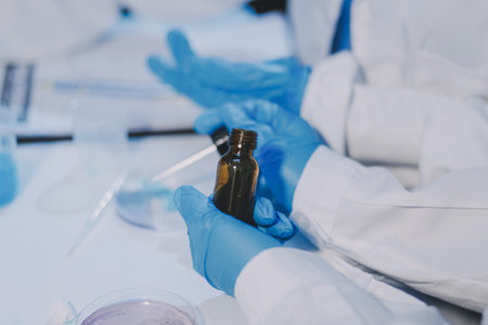 Research, experiment and medical trial being done by a scientist in a lab, science facility or hospital. One young, serious and professional researcher organizing, sorting or making a discoveryの写真素材
