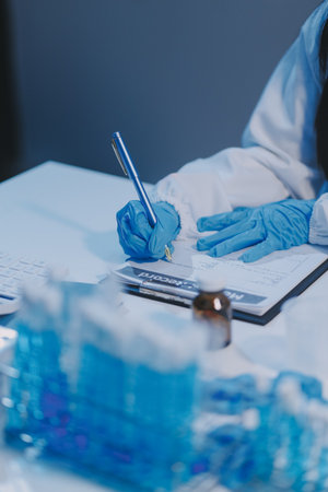 Research, experiment and medical trial being done by a scientist in a lab, science facility or hospital. One young, serious and professional researcher organizing, sorting or making a discoveryの写真素材