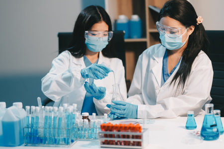 Research, experiment and medical trial being done by a scientist in a lab, science facility or hospital. One young, serious and professional researcher organizing, sorting or making a discoveryの写真素材