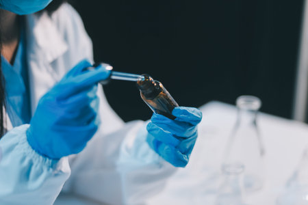 Research, experiment and medical trial being done by a scientist in a lab, science facility or hospital. One young, serious and professional researcher organizing, sorting or making a discoveryの写真素材