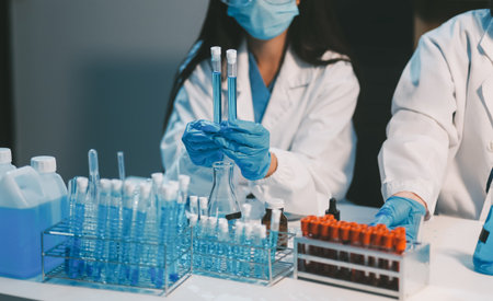 Research, experiment and medical trial being done by a scientist in a lab, science facility or hospital. One young, serious and professional researcher organizing, sorting or making a discoveryの写真素材
