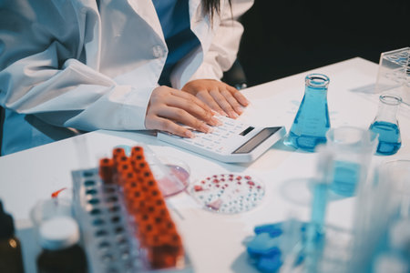 Research, experiment and medical trial being done by a scientist in a lab, science facility or hospital. One young, serious and professional researcher organizing, sorting or making a discoveryの写真素材